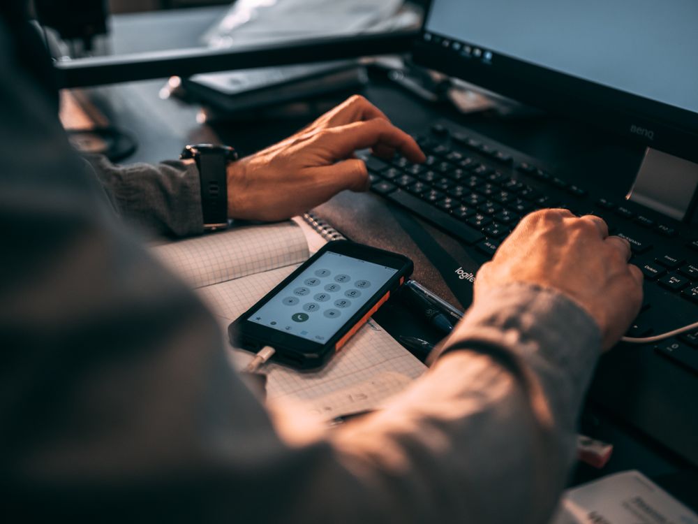 Multi-factor authentication prompt on a keyboard and smartphone